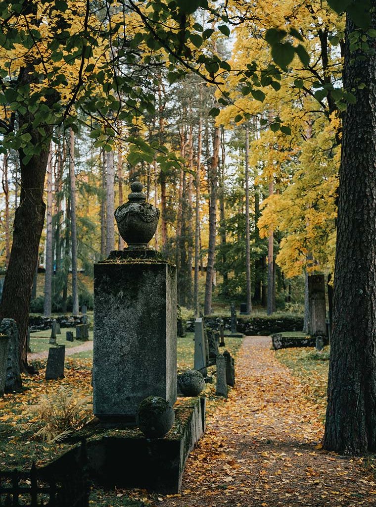 View of the old tombstone and path way across the cemetery at Autumn.
